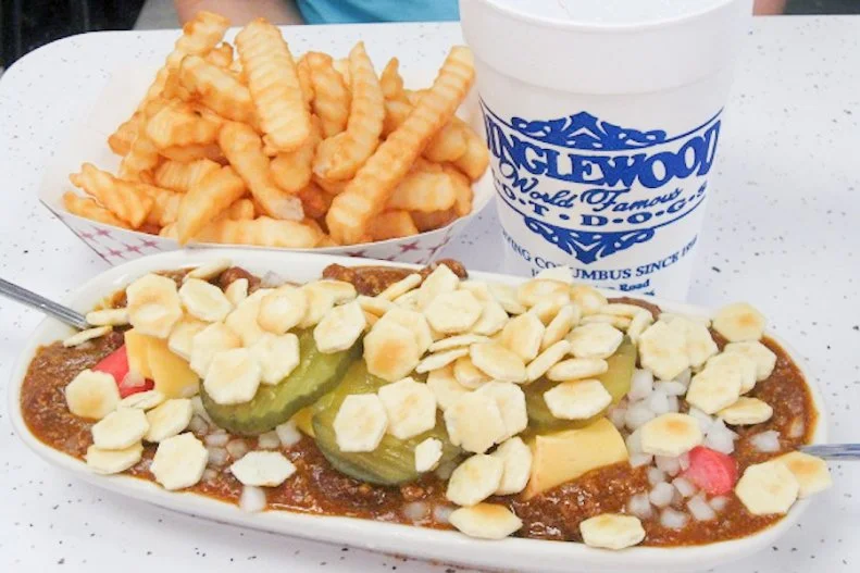 Back around 1946, an inventive Columbus, Georgia, restaurateur decided to create a unique hot dog dish with boiled chopped franks smothered in chili, onions and pickles served with a substantial handful of oyster crackers on top that was intended to be consumed with utensils. That diner went out of business, but its Scrambled Dog stuck around, becoming a Columbus-area mainstay. Itâ  s been on the menu, true to its original form, for more than 50 years at the century-old Dinglewood Pharmacy, where itâ  s served in a porcelain relish dish and a spoon. This regional classic is still so popular that accounts for 85 percent of the independent pharmacyâ  s soda fountain sales.