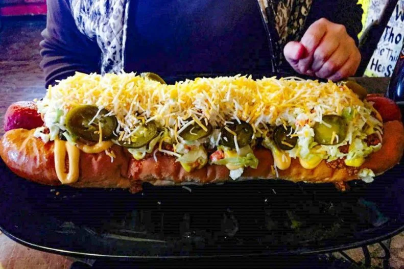 Hillbilly Hotdogs may not have the biggest sign, weenie statue or a mechanical bull corn dog, but it has one thing no other hot dog stand does: an onsite wedding chapel. For real. The restaurant â   two school buses backed up to a shed â   is a local obsession due to its gourmet dogs covered with things like kimchi and truffles. Its classic West Virginia Dog is like the stateâ  s captain of the frankfurter team, a deep-fried weenie paired with slaw, mustard, chili sauce and chopped onion in a split-top bun. While the latter is the most-popular order, the place is best known for its whopping 15-inch Homewrecker, a gut-busting take on the Mountain State favorite with added chile peppers, cheese and other belt-unbuckling toppings.