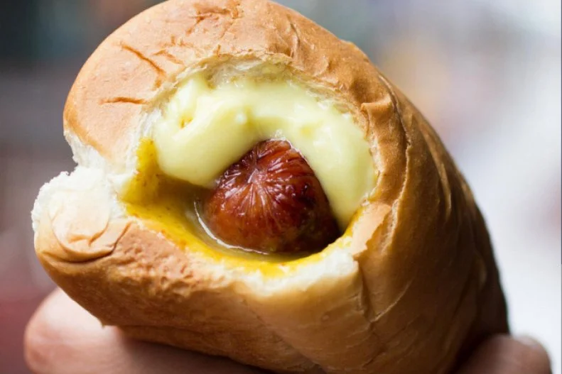 Essentially a larger, more interesting take on pigs in blankets, this Hawaiian specialty features a proprietary dog cradled inside freshly baked Hawaiian sweet bread. That bun, called a â  pukaâ   for the hole in the center, is where the shop and corresponding hot dog style get their name. Each one of these volcano-like snacks comes with choice of Polish sausage or veggie dog, garlic-lemon secret sauce (ranging in heat from mild to lava), and pick of Hawaiian fruit relish with tropical flavors including mango, pineapple, coconut and papaya. Those seeking traditional condiments can also add ketchup, yellow or Dijon mustard, sweet relish and the stateâ  s special â   and addictive â   Auntie Lilikoiâ  s Hawaiian mustard.