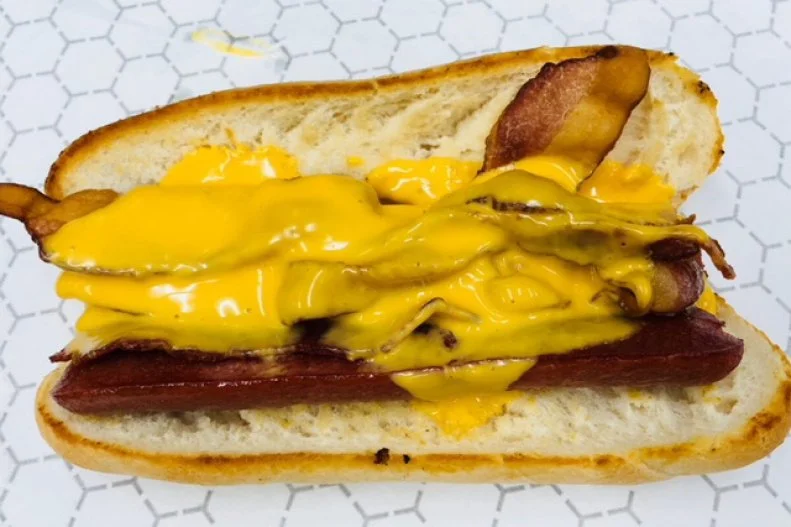 The Philly cheesesteak may be Philadelphia’s best-known claim to Cheez Whiz fame, but that golden liquid isn’t just reserved for thin-sliced steak in Eastern Pennsylvania and its surrounding South Jersey suburbs — it’s also one of the main ingredients of the ubiquitous Texas Tommy, a split-griddled hot dog loaded with bacon and a river of liquid cheese, found on nearly every greasy spoon and neighborhood grill menu in the City of Brotherly Love and beyond. Pick one up at Tony Luke’s, where you’ll get a six-inch all beef dog, split and cooked on a flat top nestled in a toasted roll with two pieces of bacon smothered in Cheez Whiz.