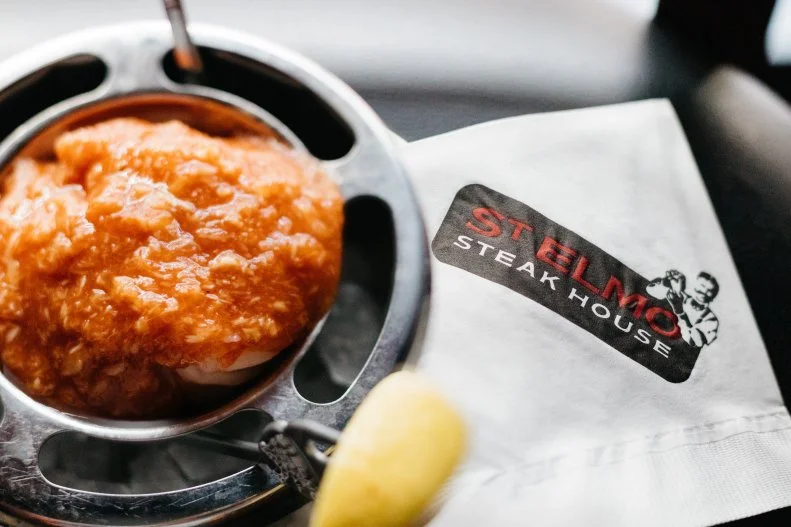 Steak lovers flock to this historic restaurant, where reservations fill up weeks in advance, and you’ll often spot visiting celebrities. The dark, masculine ambience and polished white-tablecloth service — wait staff replete with white gloves and crumb scrapers — gives the feel of an old-school men’s club. The walls are adorned with vintage Indy 500 memorabilia, and the app menu is short and sweet: shrimp cocktail. There’s no denying the mouthwatering steaks are why you go, but the shrimp cocktail is something special. Made fresh and loaded with shaved horseradish, this famous St. Elmo’s appetizer is a rite of passage and a literal hair raising experience.