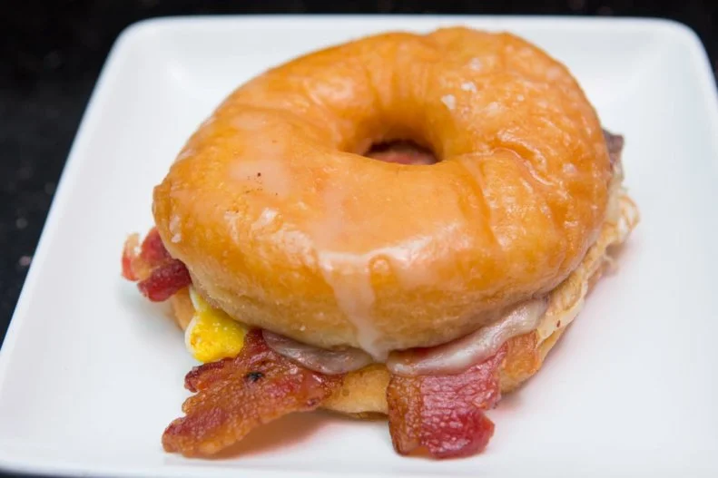 Doughnut cravings morning, noon and night? #EatGlazed. Open 24 hours a day, seven days a week, this doughnut cafÃ© fulfills doughnut fantasies at any hour. Best known for their sweet and savory maple-bacon doughnut â   aka the â  maconâ   â   Glazed features a number of doughnut delights, from yeasty favorites like the Kit Kat topped with crunchy bits of candy bar to filled dessert doughnuts like the decadent crÃ¨me brÃ»lÃ©e and strawberry cheesecake. And for when those midnight breakfast cravings hit, only the bacon, egg and cheese-stuffed Glazed breakfast sammy will do.