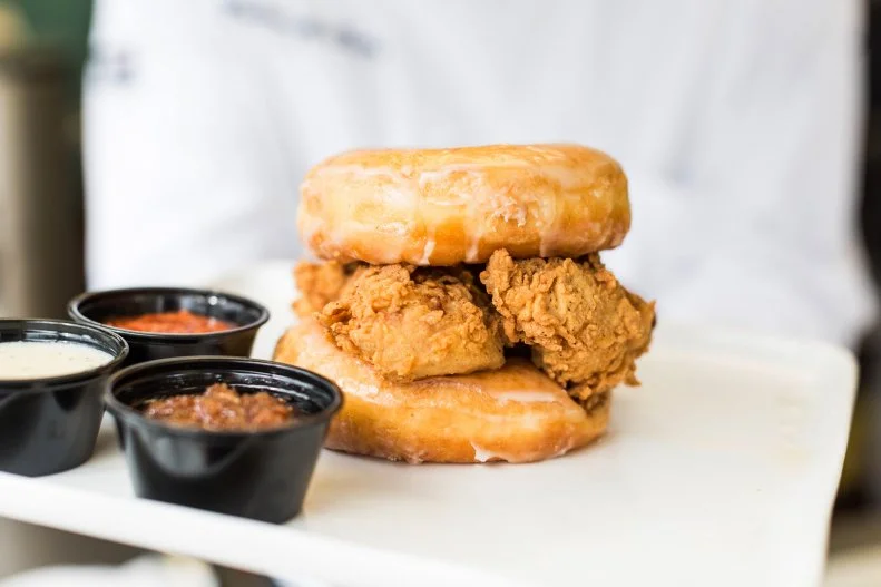 Which came first, the fried chicken or the doughnut? At Lee’s, crispy strips of fried chicken come served smack dab in between double-glazed doughnut buns for a Texas-sized breakfast sandwich you have to see to believe. The menu of everyday batched doughnuts is just as interesting, featuring classic flavors with a twist, like the Mexican chocolate iced, blueberry cake with a smooth layer of blueberry icing, or praline-topped with salty bacon bits and splashes of sticky caramel. You can always add fried chicken or an order of Houston hot chicken on the side, and you should.