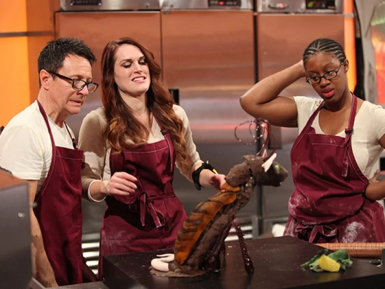 Team Grave Expectations critiques their cockroach rat ahead of judging , as seen on Halloween Wars, Season 8.
