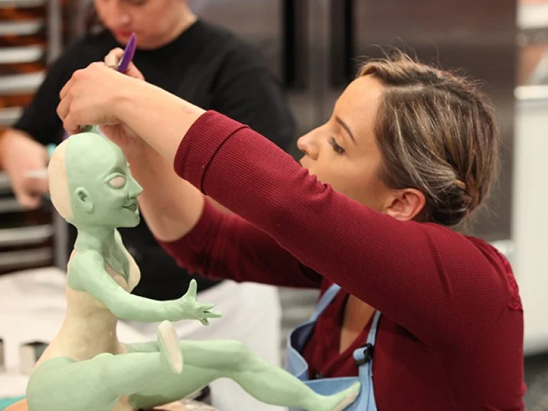 Sabrina Jurado of Monsters of Mayhem start sculpting the witch for their next challenge. , as seen on Halloween Wars, Season 8.