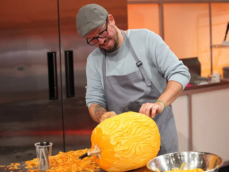 Arlen Pelletier, of Team Candied Cadavers, starts carving a pumpkin, as seen on Halloween Wars, Season 8.