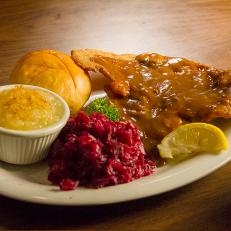 Weiner Schnitzel (veal cutlets coated with crispy breading, mushroom burgundy gravy, braised red cabbage, applesauce, and dinner roll) at Schmidt's, as seen on Comfort Food Tour, Season 2.