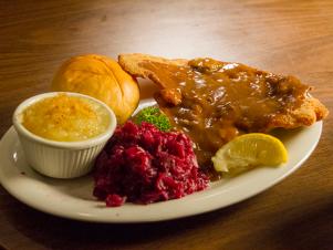 Weiner Schnitzel (veal cutlets coated with crispy breading, mushroom burgundy gravy, braised red cabbage, applesauce, and dinner roll) at Schmidt's, as seen on Comfort Food Tour, Season 2.