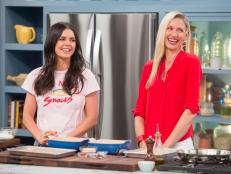 Co-host Katie Lee and guest Catherine McCord prepare quinoa-crusted chicken tenders, as seen on The Kitchen, Season 18.