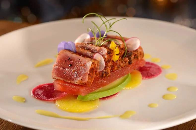 A great seafood spot in Orlando is as rare as a Nickelodeon character hanging with Mickey, so the BoardWalk Inn’s Flying Fish is quite the find. The entire place was revamped from tip to fin in 2016, creating a whimsically elegant nod to the sea with enchanting bubble-like glass fish clusters dangling from the ceiling. Chef Tim Majoras made the menu a seasonal showstopper, with entrees like Hokkaido scallop garganellii pasta studded with Key West pink shrimp, and sustainable salmon accompanied by shishito peppers and cilantro-cumin sauce.