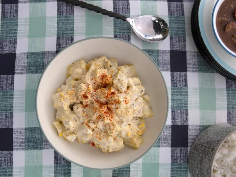 Sam and Cody Carroll's freshly mixed batch of Creole Potato Salad is prepared for a Louisiana style Party at the Pond , as seen on Cajun Aces, Season 2.