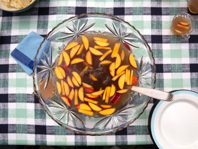 Sam and Cody Carroll's fruity rum-bsed Fish Camp Punch with fresh peaches is great for a Party at the Pond, as seen on Cajun Aces, Season 2.
