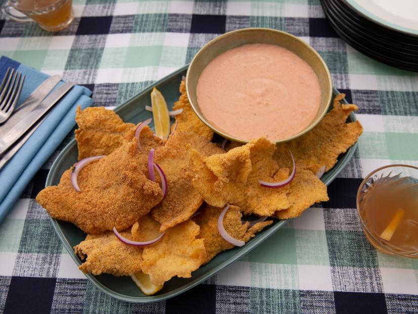 Sam and Cody Carroll's freshly fried Thin Cut Catfish with Spillway Sauce is ready to be served for their Party at the Pond as seen on Cajun Aces, Season 2.