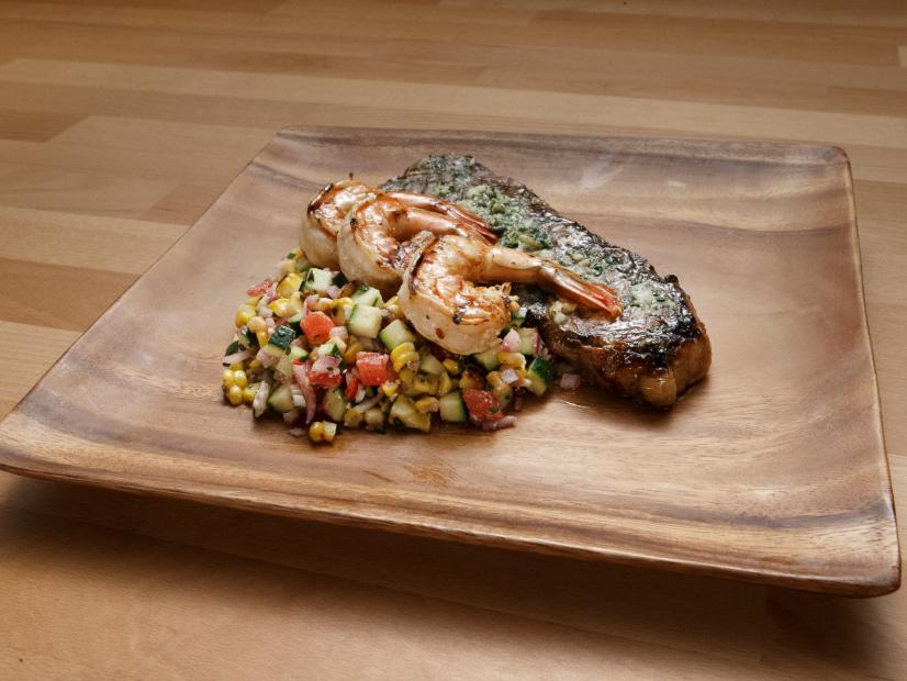 Anne Burrell's Strip Steak and Shrimp Surf and Turf with Grilled Corn Succotash is displayed, as seen on Worst Cooks in America, Season 14.