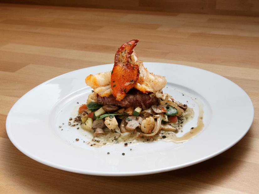 Robert Irvine's Filet and Lobster Surf and Turf with Warm Mushroom Salad is displayed, as seen on Worst Cooks in America, Season 14.