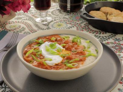 Crawfish etouffee and Grits served with a poached egg and green onions as seen on Cajun Aces, Season 2.