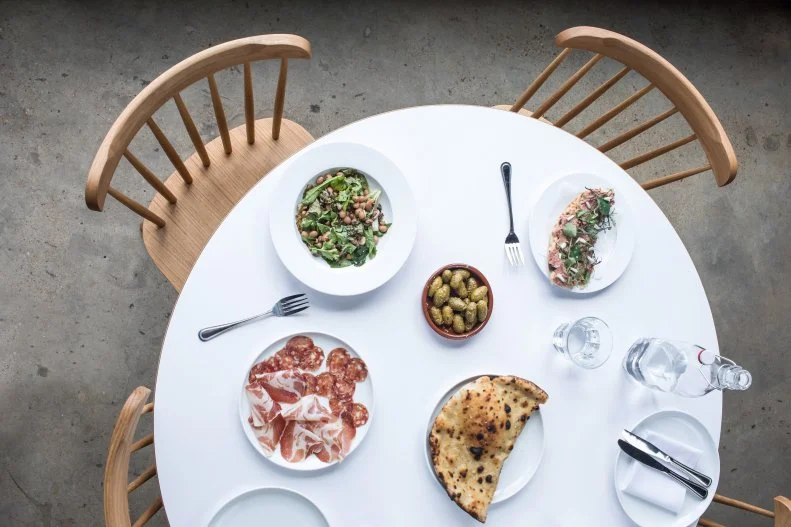 Five years after opening the acclaimed pasta-centric Rolf and Daughters, chef Philip Krajeck took a pivot, opening the pizza-focused neighborhood spot Folk in East Nashville. Once an elevator manufactory, the space’s exposed brick walls and high ceilings are now dressed with paper lantern globes, potted greens and succulents. A wood-fired oven blisters the airy, flavorful crusts of Krajeck’s inventive pizzas — the clam, laced with bonito, chiles and hints of lemon, is a must. For the full experience, don’t skip the seafood, like royal red fish with old bay, or the mussel toast, along with an expertly mixed cocktail. 