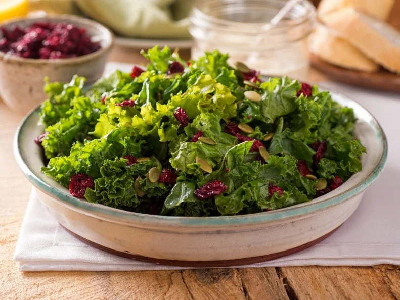 A delicious kale salad with dried cranberry and pumpkin seed.