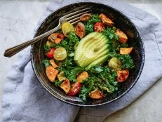 Kale, roasted yams and avocado salad on stone background/ vegan salad/ healthy/ paleo diet
