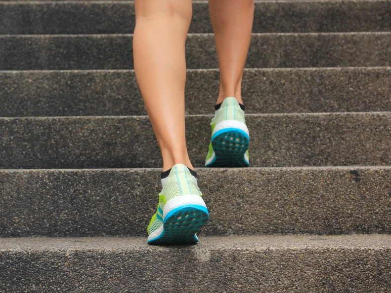 Woman walking up the stairs, Fitness woman legs running and burn fat in the body, Healthy lifestyle concept