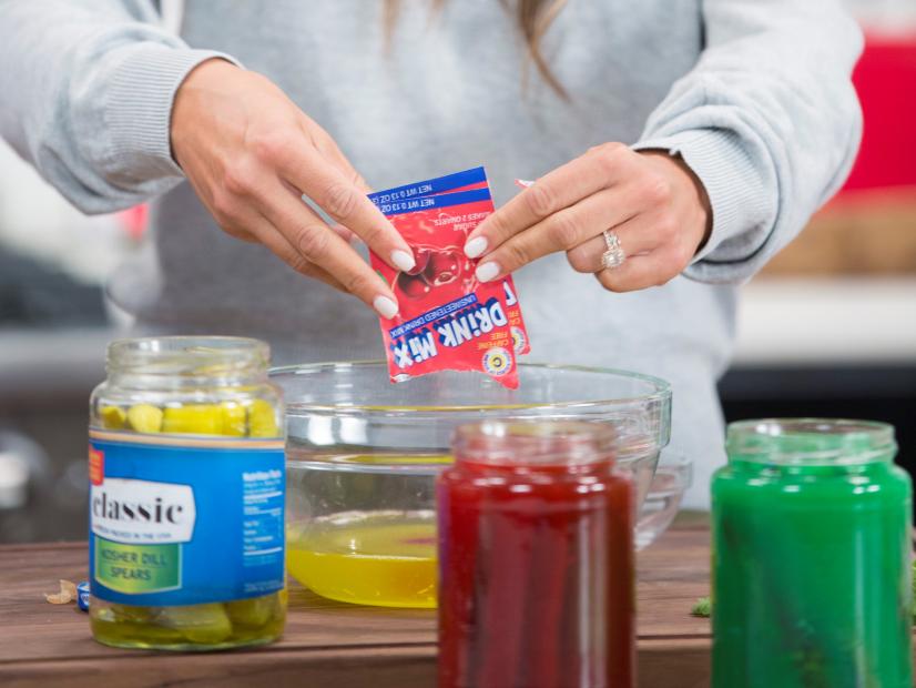 Food and Lifestyle Expert Brandi Milloy is adding drink mix to pickle juice in a mixing bol before returning juice to its container , as seen on Food Network Lets Eat Ep 109. 