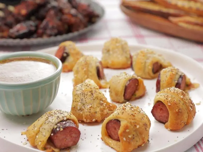 these wrapped smoked pork saugage bites are called Kajun Kolaches and is served wih Creole Honey Mustard. The sausage is made at one of Sam & Cody's restaurants as seen on Cajun Aces