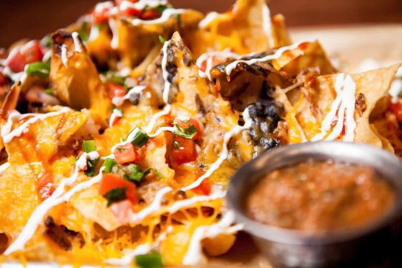Kansas is cattle country, and the nachos devoured at Augustino Brewing Company in Wichita pay homage to the state’s carnivorous leanings. Small, slow-smoked batches of brisket are evenly spread throughout the layers of just-made tortilla chips. Lest folks forget they are kicking back in a brewery, the sour cream and sweet BBQ sauce incorporated into the nachos are laced with craft beer produced on the premises.