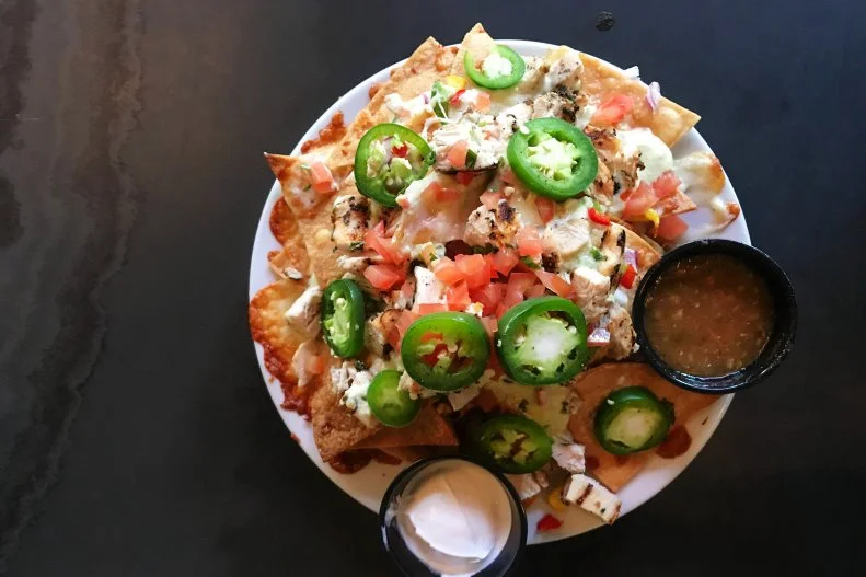 Stellar nachos abound in Tucson, but those craving an atmospheric dose of history with their meal should head downtown to the Hotel Congress. Dating from 1919, the property is home to Cup Cafe, where the comforting bar menu illuminates Picacho Nachos. Layered with Jack cheese, bean dip, chili con queso, pepper, onion, tomato and salsa, these nachos can — and should — be ordered with the optional local-chorizo splurge.