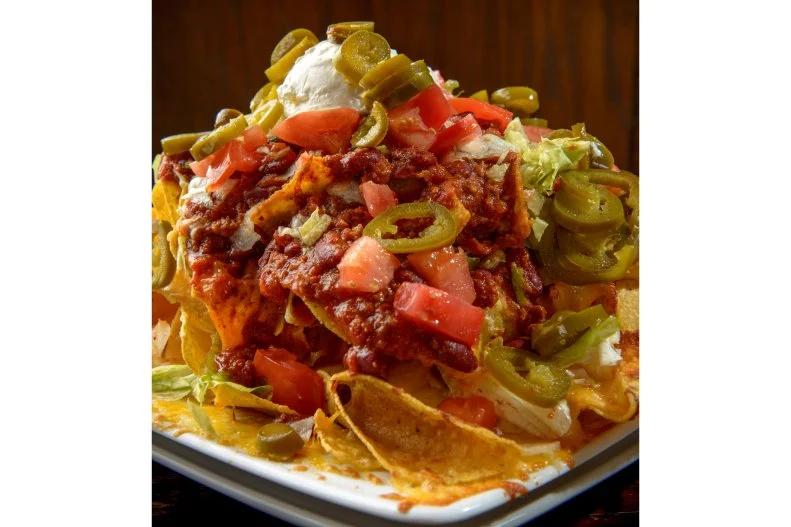 Adjacent to the University of Delaware campus in Newark, Deer Park Tavern — and the inn that stood in its place from 1747 to 1851 — has hosted numerous historic heavyweights, from George Washington to Edgar Allan Poe, and is rumored to have been a Civil War-era stop on the Underground Railroad. The tavern’s Los Nachos Grande, a mess of chicken, chili, sour cream, jalapeno, lettuce and tomato, is a dish repeatedly sought out by the guests of this lively college bar.