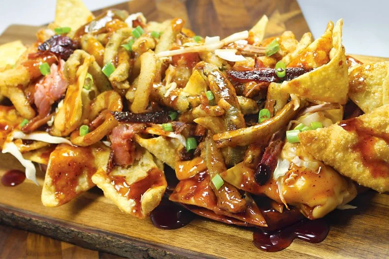 Kansas City usually gets the lion’s share of Missouri BBQ accolades, but the entertainment epicenter of Branson also flaunts some gratifying ’cue at Gettin’ Basted. Before tackling the burnt-ends plate at this low-key place run by vets of the championship circuit, seek out the Basted Nachos. Crispy fried wontons are an inviting substitute for tortilla chips, folded with pulled pork, pepper Jack cheese sauce, slaw, “onionpeno” straws and green onion.
