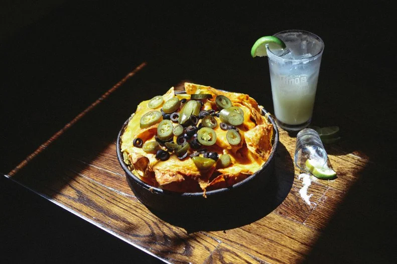 Deep-dish pizza is so embedded in Chicago’s culinary canon that it’s not surprising one of the city’s premier purveyors of this specialty, Gino’s East, cranks out a nacho riff on the bready pie. First, housemade tortilla chips are layered in a pizza pan. Then, refried beans and melted cheddar cheese are added, followed by black olives, jalapenos and salsa.