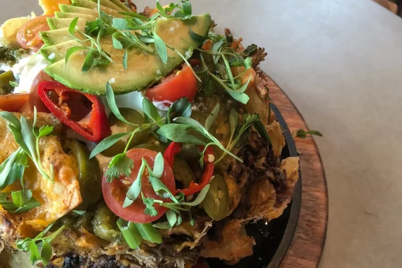 Live music and craft cocktails like the Lavender Milk Punch are enough incentive to spend an evening holed up at the downtown Salt Lake City restaurant and bar Lake Effect. But the Tin Can Nachos with barbacoa, carnitas, ancho chicken or jackfruit certainly sweeten the deal. Housemade white corn tortilla chips, cheddar cheese, black beans and jalapeno are beautifully layered and baked in a tin can before getting anointed with tomatillo salsa, crema fresca, cherry tomato, scallion and avocado.