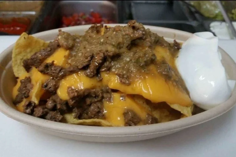 It was a small menu â   tacos, burritos, quesadillas â   but now that the bare-bones Luchador Tacos has outgrown its South Paris carry-out trailer and become a proper restaurant, the nachos specials are welcome permanent fixtures. Mirroring the hearty rendition relished in Chef-Owner Katherine Mitchellâ  s native East Los Angeles, the carne asada nachos simply unite chunks of juicy meat with cheese, green salsa and sour cream.