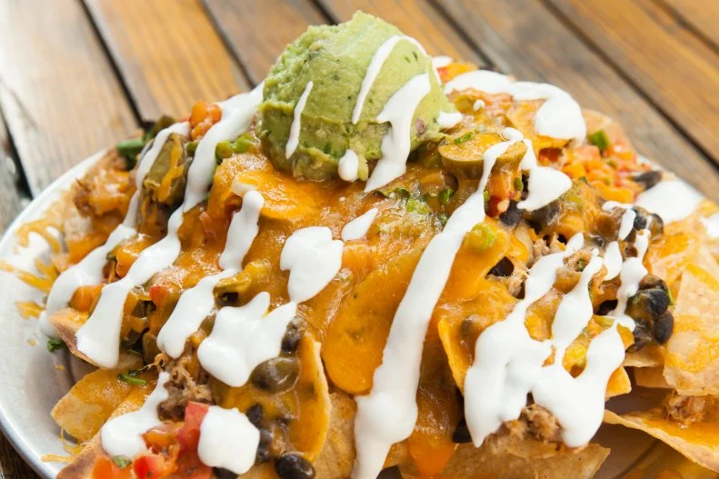 In downtown Raleigh, the Raleigh Times Bar is a vibrant hangout — sometimes buoyed by live banjo music — set in the former headquarters of its namesake newspaper. For its nachos, the bar turns to sister restaurant The Pit for some whole-hog barbecue, then meshes it with a cheddar-Jack sauce, jalapeno, cilantro, pico de gallo and guacamole.