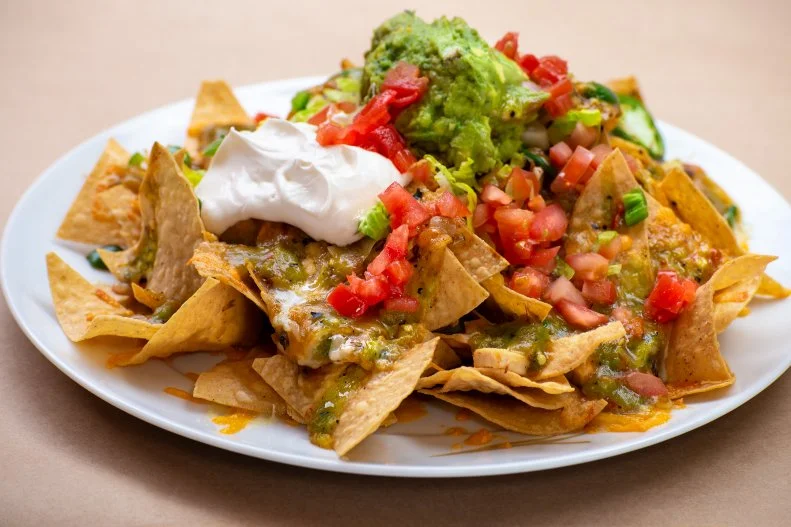 Green chile pervades New Mexican cooking, and the nachos at earthy, Southwestern-style Rio Chama Steakhouse in downtown Santa Fe are no exception. Topped with a melange of fire-roasted chile sauce, chicken, cheese, pico de gallo, sour cream and guacamole, these nachos often pave the way for the 48-hour-brined prime rib.