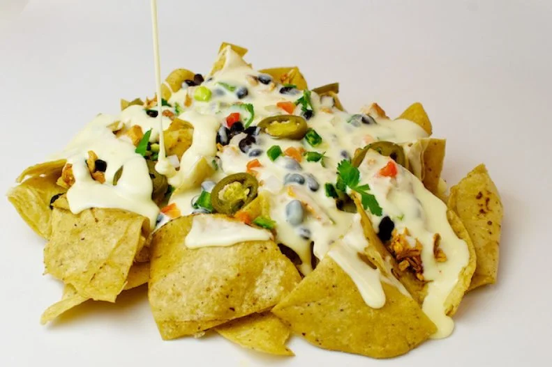 Half-pound tamales attract lines at the family-run Tamale Place, a trio of esteemed Indianapolis eateries. Nachos, heaped with steak, veggies or chipotle chicken, are also highlights. Underneath the pickled jalapenos and habanero salsita are quality tortilla chips that The Tamale Place makes by first boiling corn and then laboriously grinding it into masa.