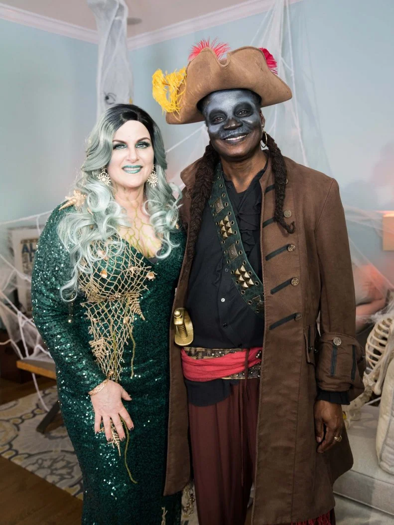 Vertical shot of Trisha the zombie sea sorceress and her captain, Robert, as seen on Food Network’s Trisha’s Southern Kitchen Season 12