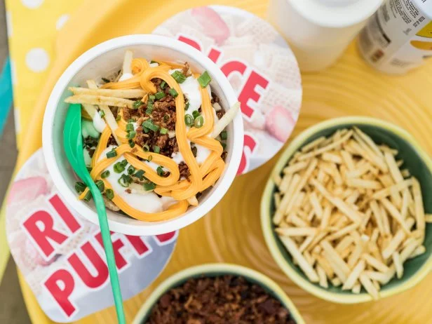 Nick Mangold and Sunny Anderson make Loaded Potato Rice Cereal Bowls, as seen on Food Network's The Kitchen 