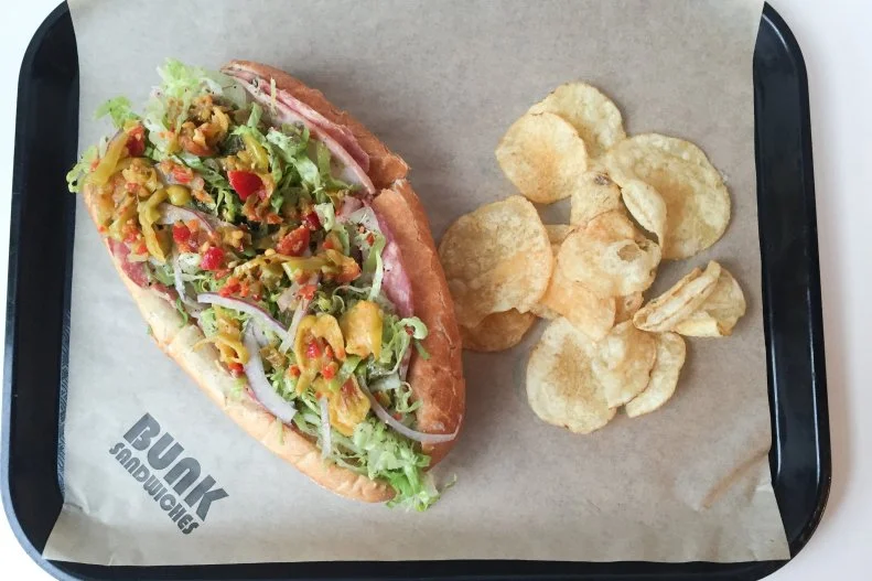 Grinders, subs, hoagies and even the muffuletta: If an American city is home to Italians, it’s home to some version of an Italian sandwich. There are classics like Amato’s in Maine, Capriotti’s in Delaware or Ranelli’s in Birmingham. Each is good, with devout followers. However, newcomer Bunk Sandwiches in Portland has quickly surged to the spotlight. The Italian cured meats sandwich is a two-hander stuffed to the brim with ham, Olympia Provisions salami cotto and capicola, as well as marinated hot peppers and provolone picante.