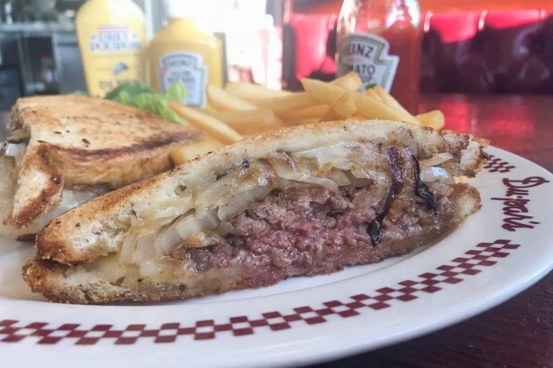 Half-cheeseburger, half-grilled cheese with some onion thrown in, the patty melt was invented in 1932 by restaurateur Tiny Naylor in Los Angeles. It’s been on the menu at Du-Par’s Restaurant & Bakery at the Farmer’s Market since 1938. Now owned by Tiny’s son Biff (as of 2007) the historic diner offers a patty melt true to Tiny’s original recipe. A coarse Harris Ranch chuck patty is covered with sweet caramelized onions and melted Swiss cheese on grilled rye bread that is so buttery and delicious, it can barely hold itself together. You’ll want to make sure to get an extra napkin (or three) with this decadent SoCal mainstay.