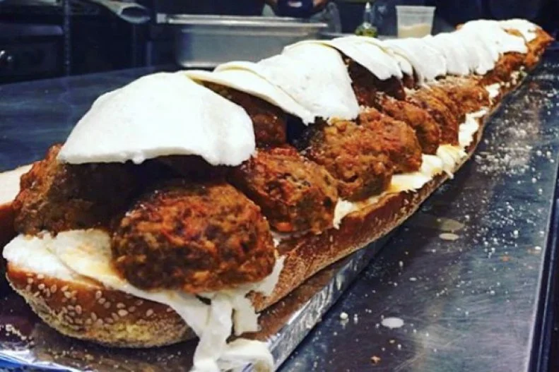 Balls of meat date back to some of the earliest Arab cookbooks, but classic meatballs are a distinctly Italian-American tradition, especially when tucked into a sub roll. One of the oldest and best examples can be found at Defonteâ  s in Red Hook, Brooklyn. The 1922 sandwich shop offers a huge meatball parm sub, dubbed the Dino, with sweet tomato sauce and mozzarella, flowing from the side of the seeded Italian bread.