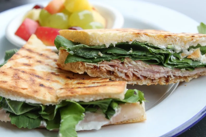 It’s hard to find a ham and cheese that’s better than the one you make at home… unless you head to Feast! in Charlottesville, Virginia. The local-centric market and deli offers an impeccable rosemary ham and goat cheese sandwich that celebrates the flavors of the city and nearby Shenandoah Valley. The creamy and tangy chevre is handcrafted in small batches down the road at Caromont Farm. It’s counterbalanced with a sweet and spicy plum chutney from Virginia Chutney Company and peppery arugula from Manakintowne Farm, all layered together on fresh focaccia bread made by Albemarle Baking Company, then warmed on the grill. For those who want to eat more than one, all of the ingredients can be purchased at the neighboring specialty store, so you can up your at-home ham and cheese game, as well.