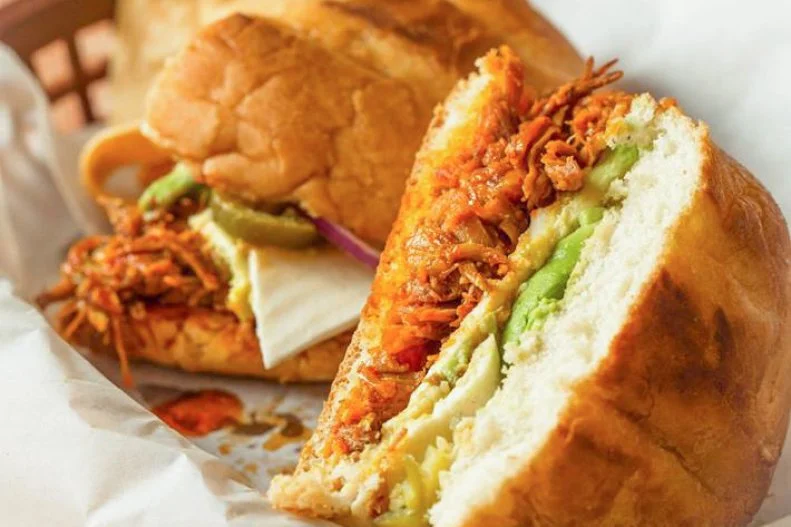 The Mexican torta, a soft oblong roll filled with flavorful ingredients, has made it to the essential sandwich list in cities and towns around the United States. One of the buzziest versions is the Pierna Enchilada at San Franciscoâ  s La Torta Gorda. Locals will forego their cityâ  s infamous infant-sized burritos in favor of these Puebla-style specialties. Pork butt is marinated in freshly squeezed orange juice and simple spices, slowly simmered for four hours, then pulled into chewy chunks and coated with a smoky, sweet and fiery guajillo pepper-scented adobo salsa until it melts together. That juicy resulting pork is heightened with housemade refried beans, a thick slice of queso fresco, mayo, red onion and avocado on that requisite oblong roll.