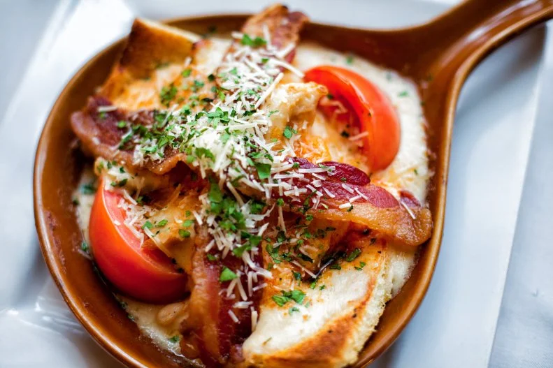 This creamy, open-faced turkey sandwich was created to recharge the batteries of dinner-dance patrons when Chef Fred Schmidt introduced it to the Brown Hotel’s menu back in 1926. Schmidt piled sliced turkey atop a piece of toast, covered it with Mornay sauce, adorned it with Roma tomato halves and toast points, passed the lot under a hot broiler and added crisp bacon slices. Now a Kentucky sensation, the Hot Brown has spawned numerous best-of competitions. Try one where it was created.