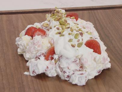 Big Delicious Mess prepared by Chef Stuart O'Keffe is ready to serve, made with crushed meringues, whip cream, rasberries, strawberries, blueberries, all mixed together drizzled with chocolate sauce topped with whip cream and some pistachios,  as seen on Food Network Lets Eat Ep 108.
