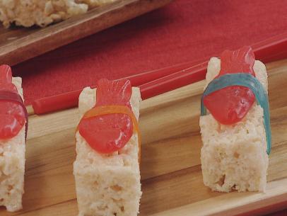 Candy Sushi prepared by food and lifestyle expert mad with rice cereal treats cut into slices, swedish fish placed ontop, finished with some candy leather wrapped around for final sushi look,  as seen on Food Network Lets Eat Ep 108.
