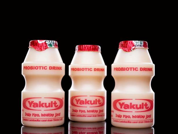 New Delhi, India - October 31, 2013: Japanese probiotic drink Yakult isolated on a black studio background.