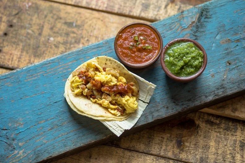 In a city where Taco Tuesday is widely celebrated, knowing where to score is a must — and Tacos A Go Go should be part of your regular routine. Open early each morning and into the wee hours of the night, it offers breakfast tacos with toppings like grilled potato and chorizo scrambled into eggs for $2.59. Pure Mexican street tacos like the Pastor, with tender slices of guajillo-marinated pork fajita meat topped with juicy bits of pineapple, are under $4. Add on an order of chips and queso and a mango-flavored Jarrito for a well-balanced Taco Tuesday.