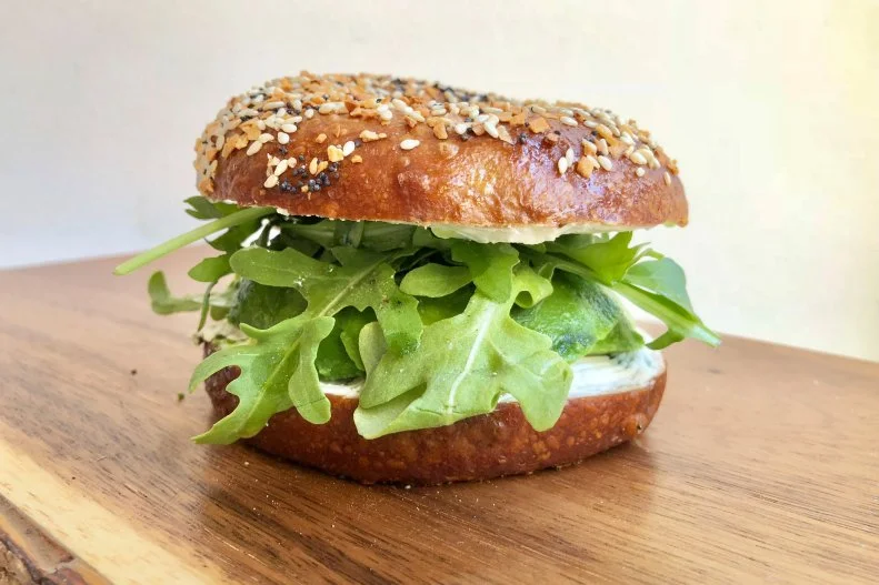 Mindy Segal is the queen of hot chocolate (and pastries, and pretty much anything delicious), but she also makes a mean bagel. At her Revival Hall location, she puts a twist on avocado toast by slathering black pepper-and-scallion cream cheese on that gorgeous bagel, topping it with a hearty amount of avocado and garnishing with arugula, with extra virgin olive oil, salt and pepper.