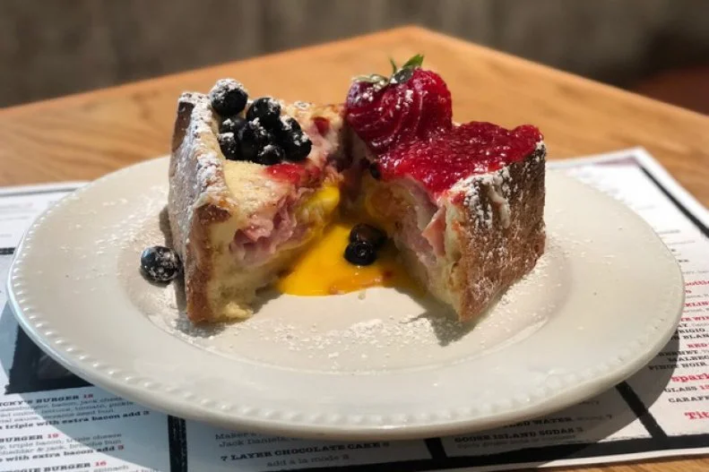 Consider this a supersized version of any Monte Cristo you've had before. This version, served at Miss Ricky's in Virgin Hotels Chicago, starts with brioche that's stuffed with ham, turkey, white cheddar and a poached egg whose yolk runs when you cut into it. It's topped with a hearty spread of raspberry jam and is finished with blueberries and strawberries.